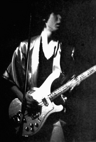 Joe Fraser playing bass in a kimono